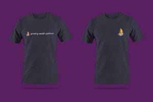 Two navy blue t-shirts featuring the Growing Wealth Platform logo with orange and purple sailboat and white 'growing wealth platform' text, displayed on a purple background