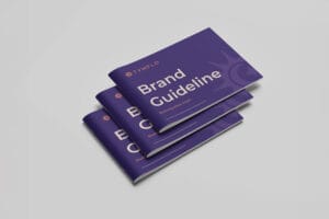 Stack of three TymFlo brand guideline booklets with purple covers featuring the sunburst logo and title 'Brand Guideline: Marketing made simple'