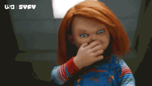 Chucky doll waving goodbye with his hand