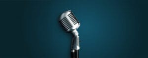 Vintage microphone in a teal background