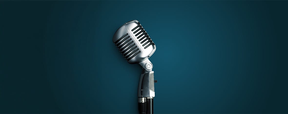 Vintage microphone in a teal background